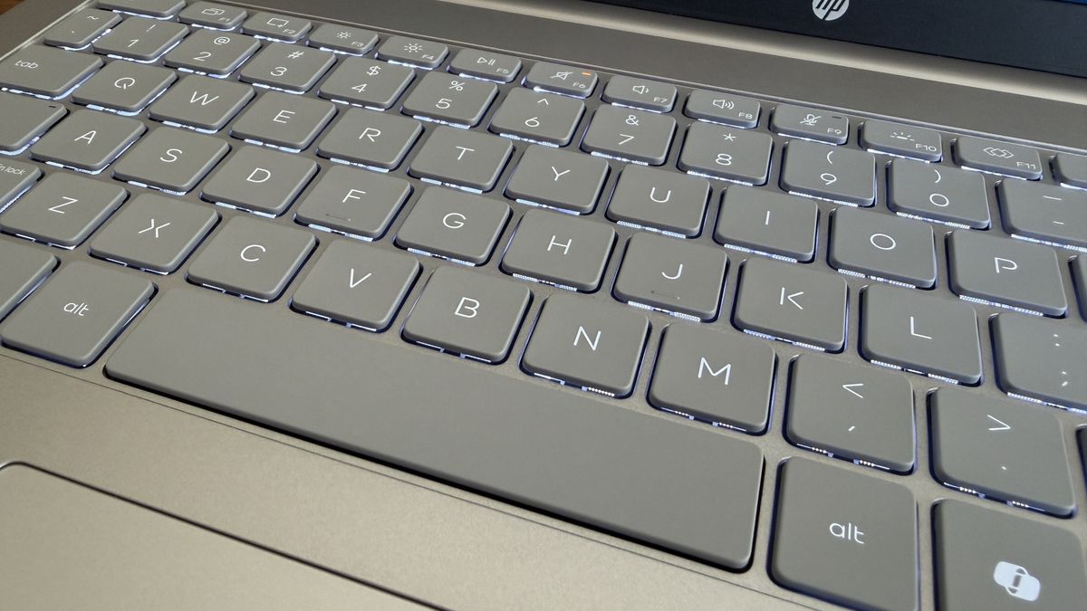 Close-up of a gray OmniBook 3 laptop keyboard with illuminated keys featuring letters, numbers, and function keys.