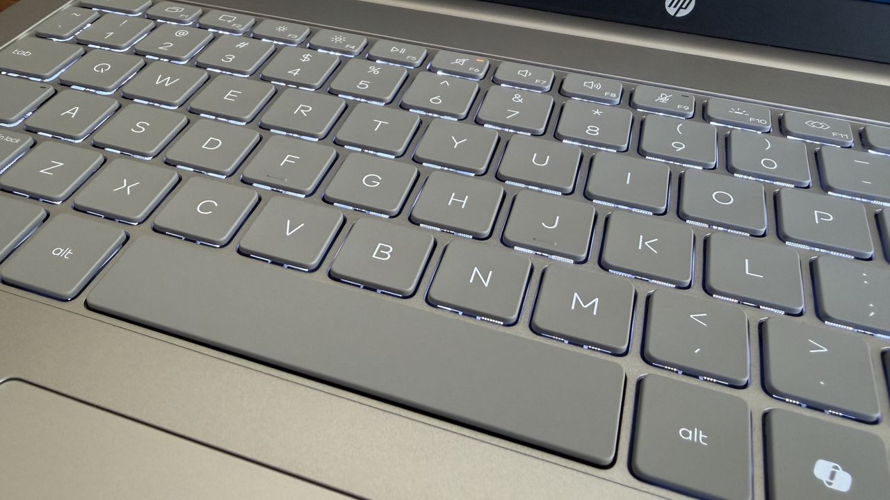 Close-up of a gray OmniBook 3 laptop keyboard with illuminated keys featuring letters, numbers, and function keys.