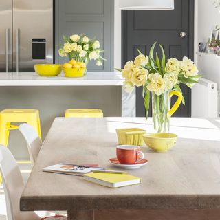 grey kitchen with yellow stools at island