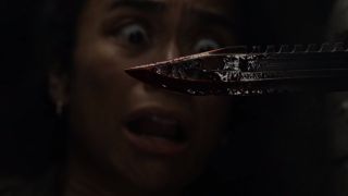 lauren ridloff's connie staring at bloody knife through wall on the walking dead