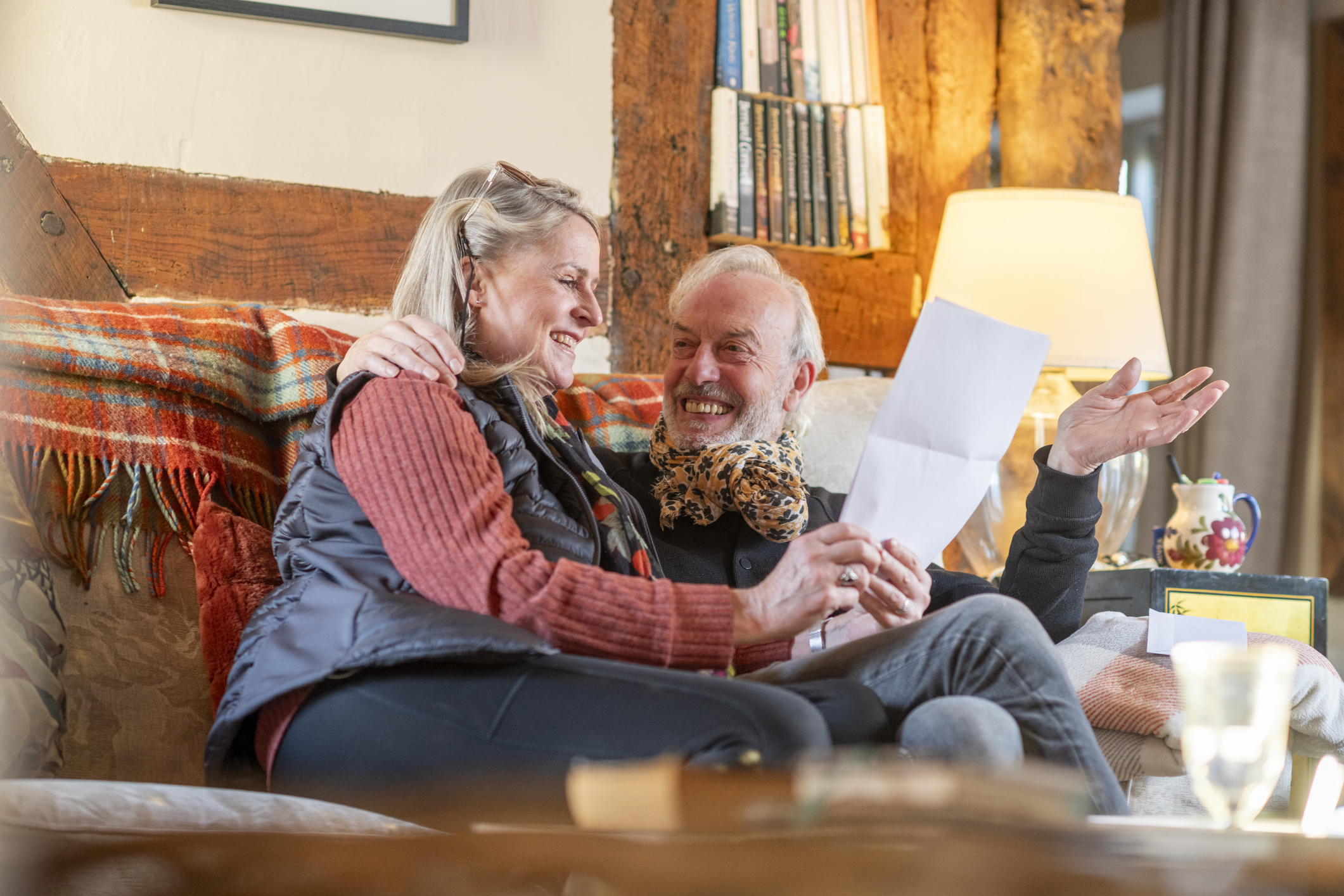 a happy couple reading good news from a statement 