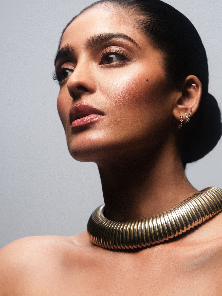 Mandeep Dhillon in a beauty portrait shot by Jack Waterlot. She is wearing a thick gold metal Swarovski necklace.