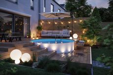 outdoor entertaining area with pool and lighting