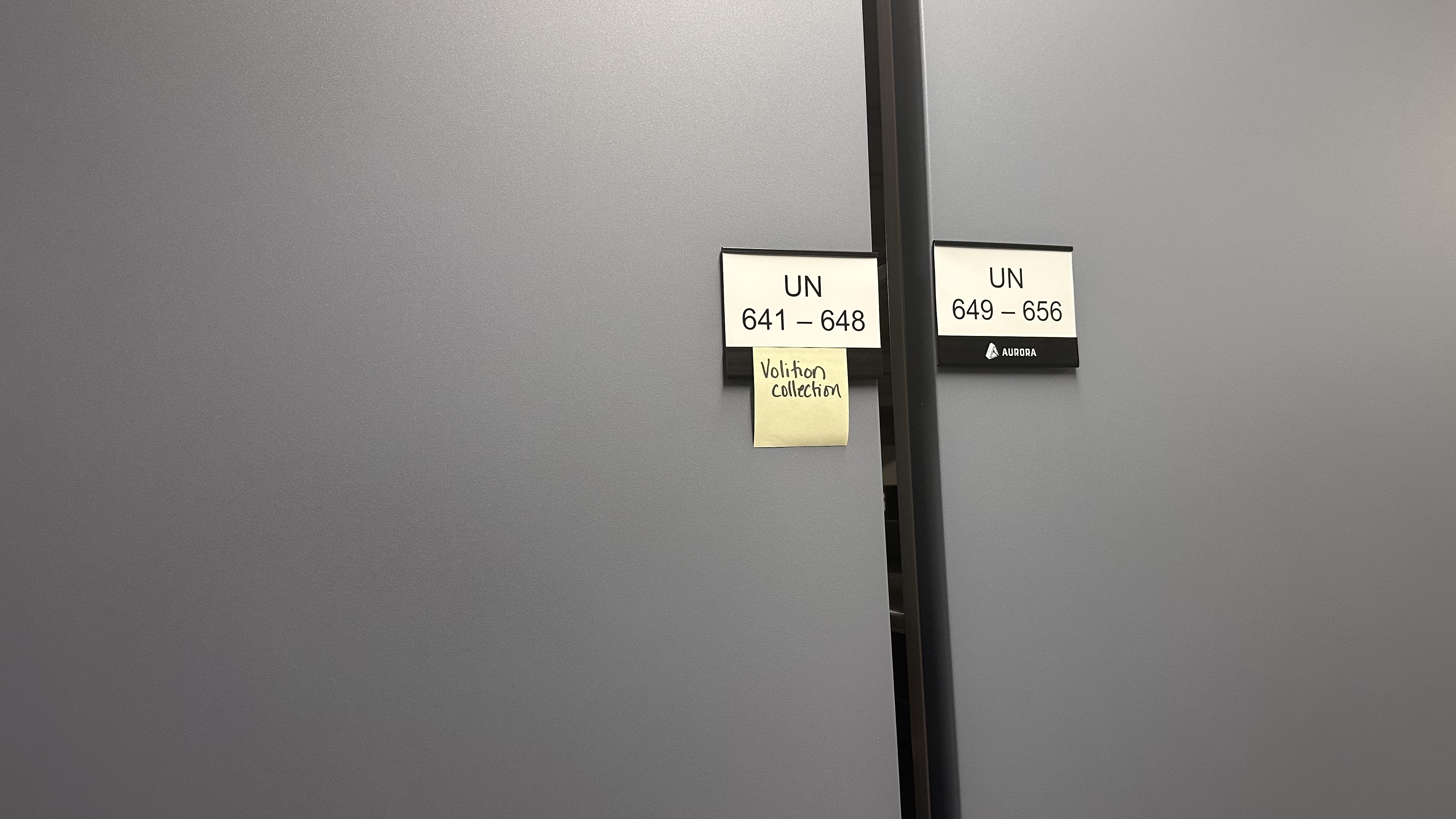A nondescript door is market with a Post-it note that says &quot;Volition Collection&quot;