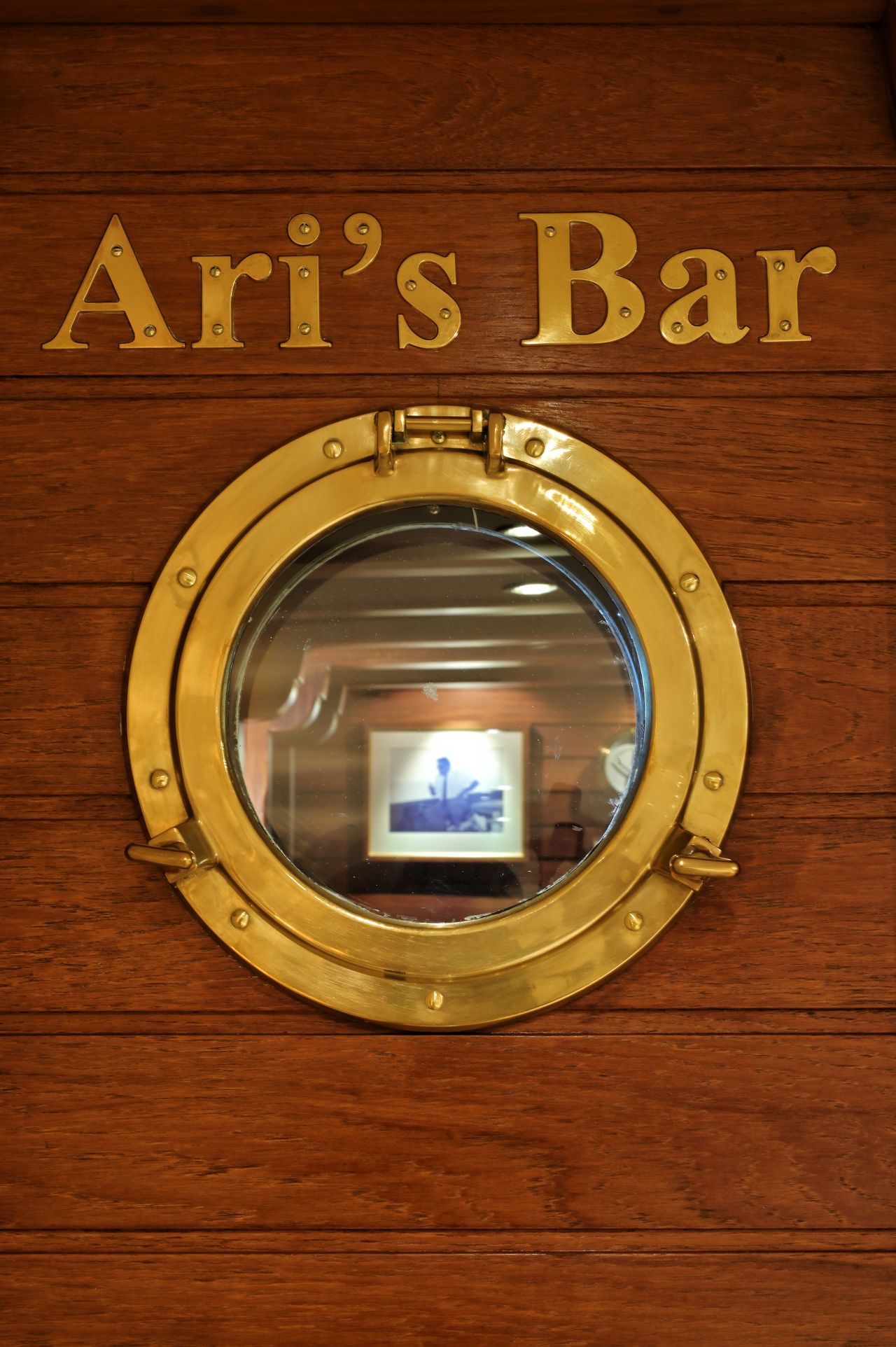 Close up of Ari's Bar door, which has a porthole