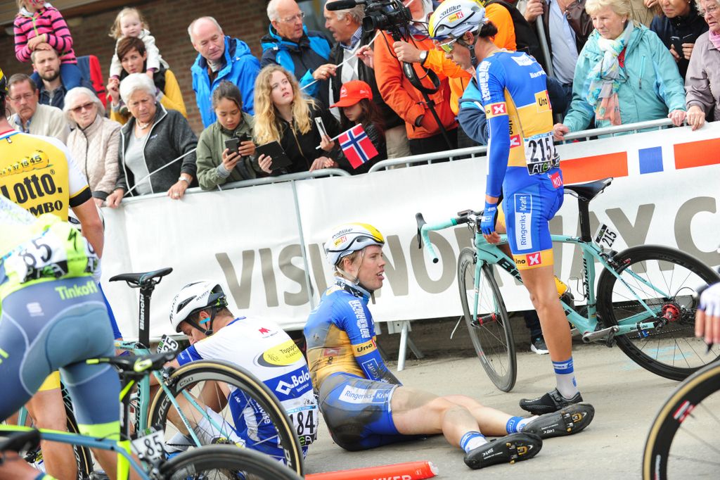 Riders start to pick themselves up after the crash
