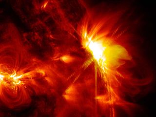 A solar flare erupts on the far right side of the sun March 12, 2014.