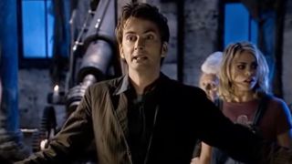 The 10th Doctor standing in front of Rose in Doctor Who.