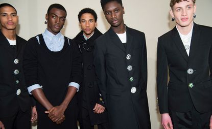 Group of models posing for the camera against a white backdrop