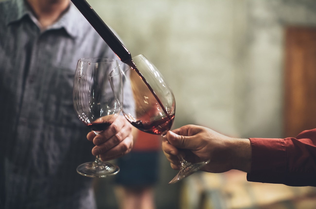 pouring wine in a cellar