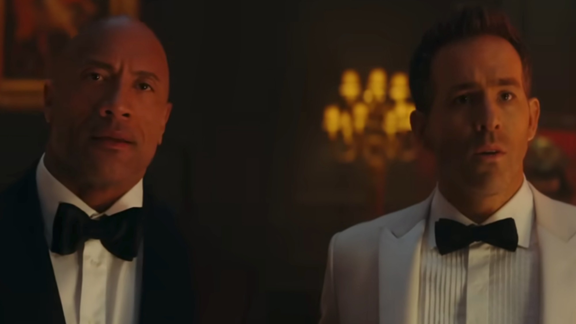 Dwayne Johnson and Ryan Reynolds wearing tuxedos in Red Notice