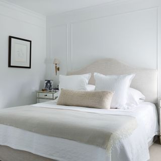 all white bedroom with large bed and white bedding in Georgian home