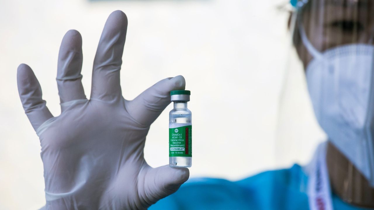 A health worker holds up a vial of Covishield, AstraZeneca-Oxford&#039;s Covid-19 coronavirus vaccine, at the Ayeyarwady Covid Center in Yangon on January 27, 2021. (Photo by Sai Aung Main / AFP) (Photo by SAI AUNG MAIN/AFP via Getty Images)