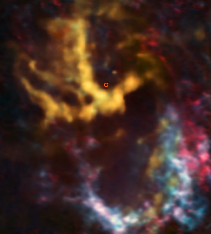 An image from the Atacama Large Millimeter/submillimeter Array (ALMA) shows molecular gas clouds around the region where the Milky Way&#039;s central, supermassive black hole is known to exist. That region, highlighted in red, looks dark and silent.