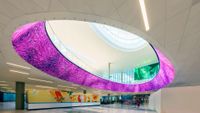 The Houston airport with a digital signage ring with colorful designs.