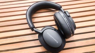 Best headphones hero image showing Bowers & Wilkins PX7 S2 on a table outside