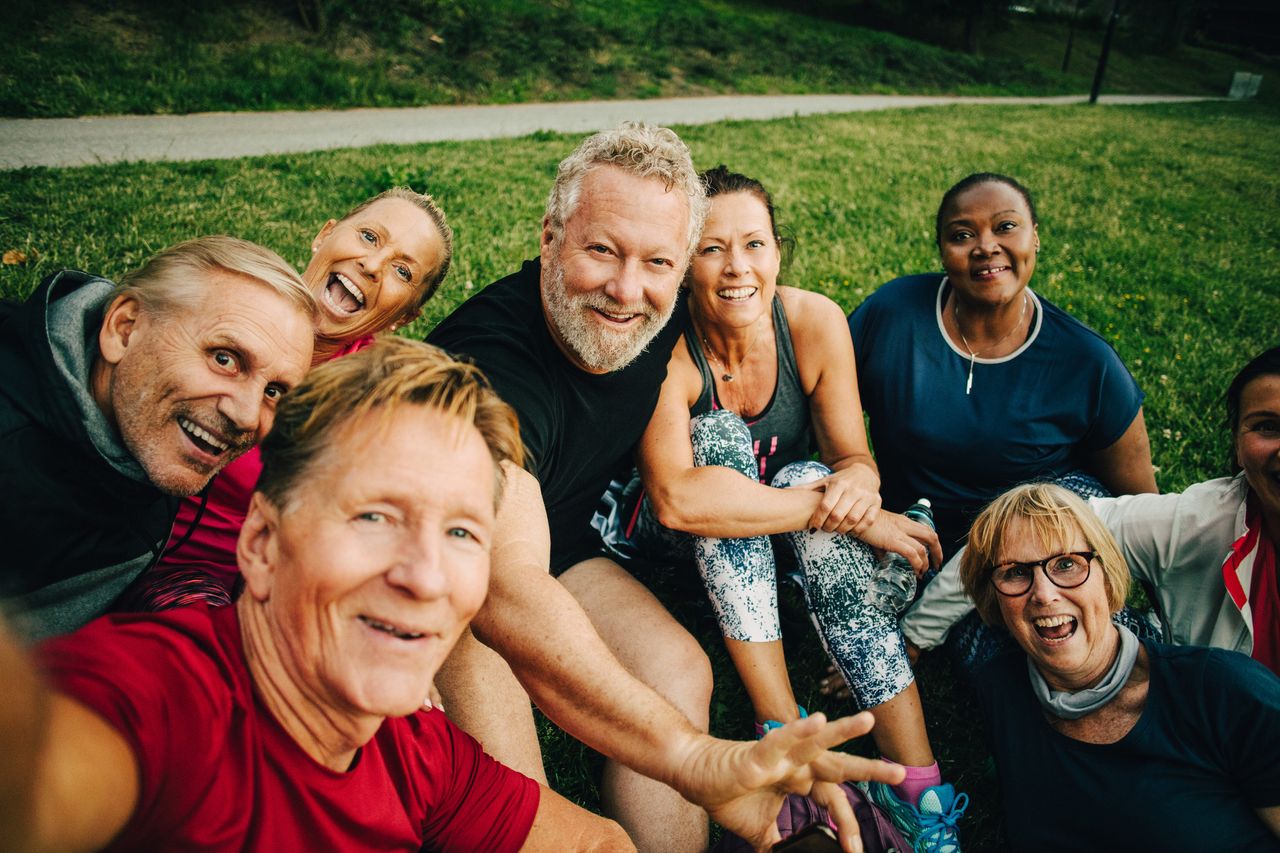 A group of retired friends takes a selfie.