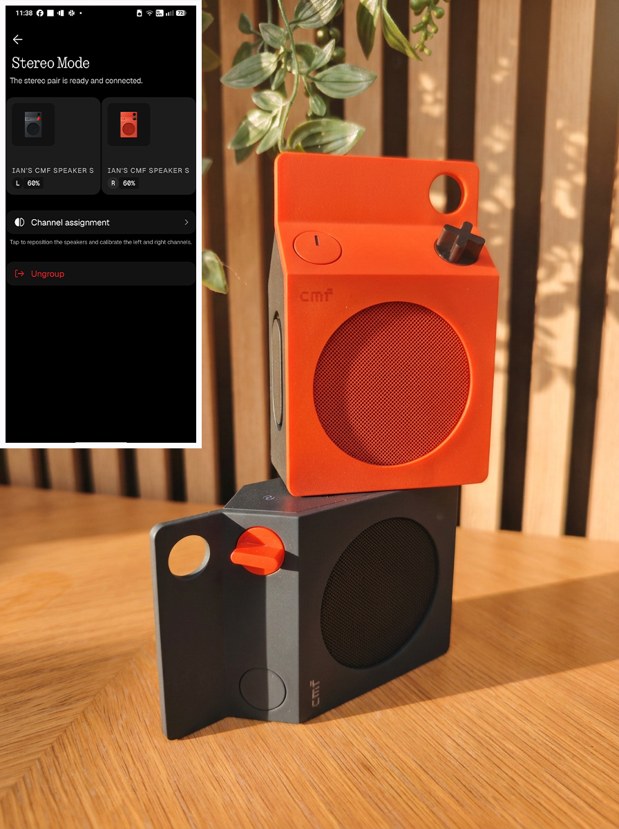 Small orange and black speakers on a wooden table
