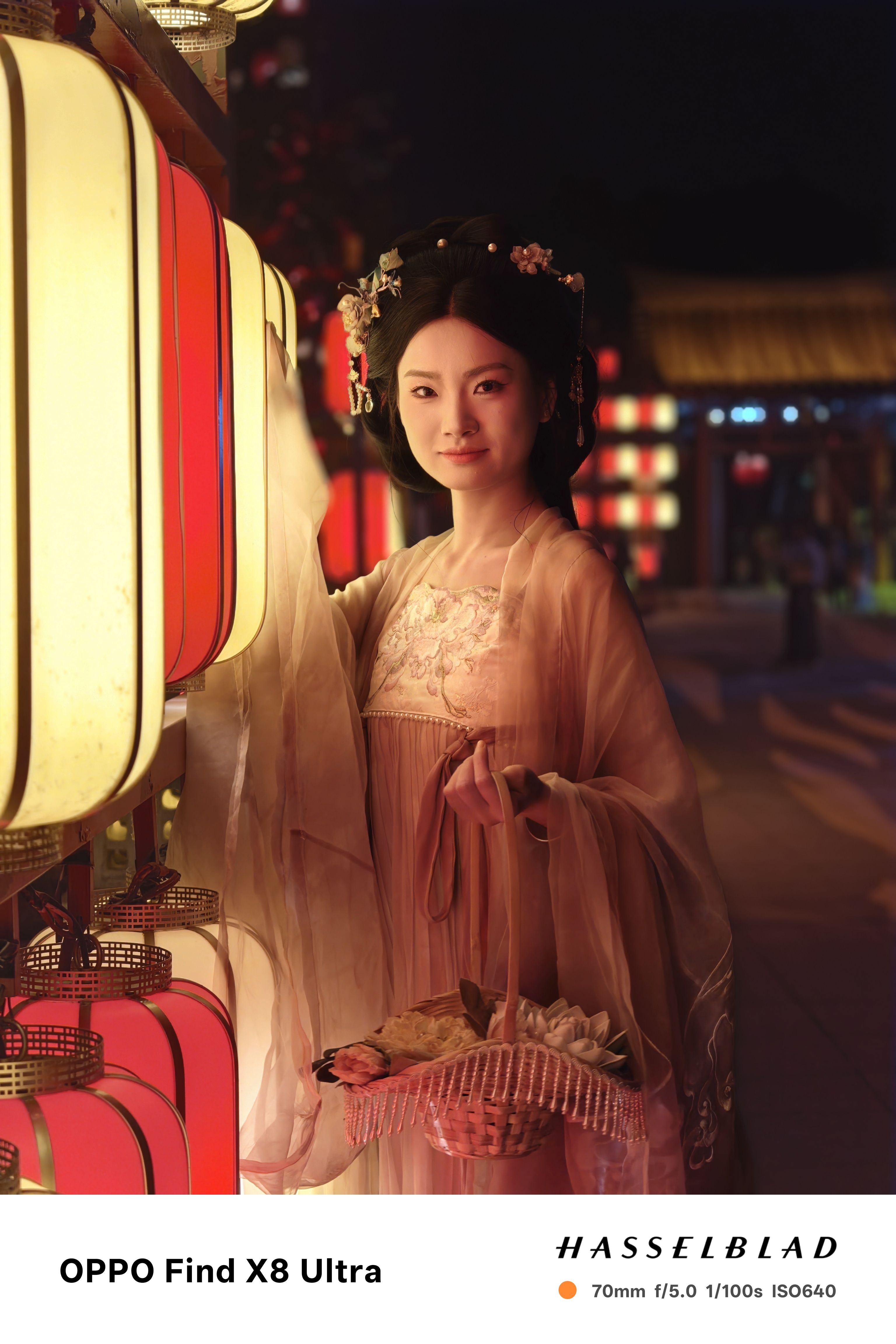 A person in traditional Chinese dress posing with a basket of flowers