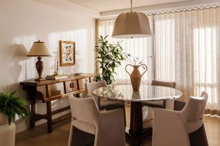 a dining room with a fabric pendant light