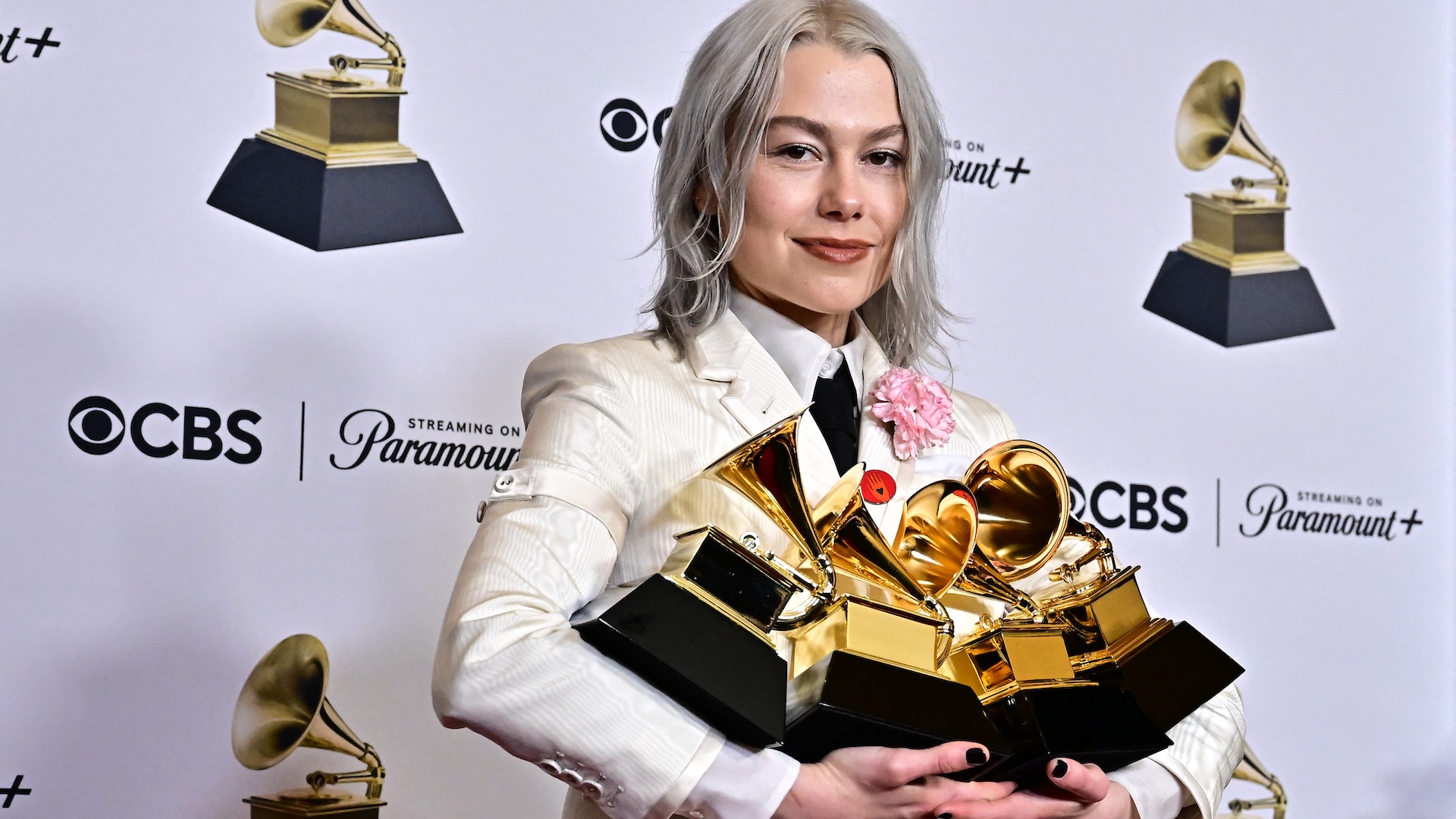 US singer-songwriter Phoebe Bridgers poses in the press room with several Grammy Awards