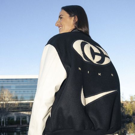 Caitlin Clark modeling a jacket from her collaboration with Nike.