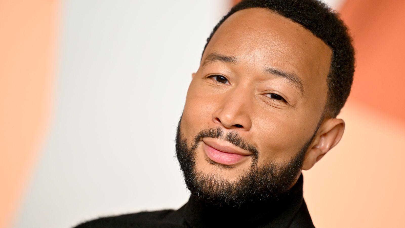 john legend on an orange background