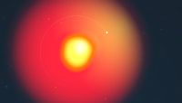 a blurry bright yellow splotch is auraed by an orange red hue. faintly around it, a thin circle, with a bright point the to the splotch's top right.