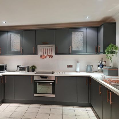 kitchen with painted grey cabinets and copper accessories