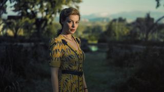 Gillian Jacobs as Mary Jayne Gold wearing a yellow patterned dress