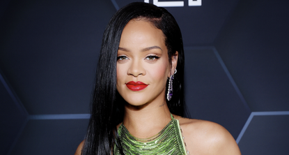 Rihanna celebrates Fenty Beauty &amp; Fenty Skin at Goya Studios on February 11, 2022 in Los Angeles, California wearing a green sequin top and a glossy red lip 