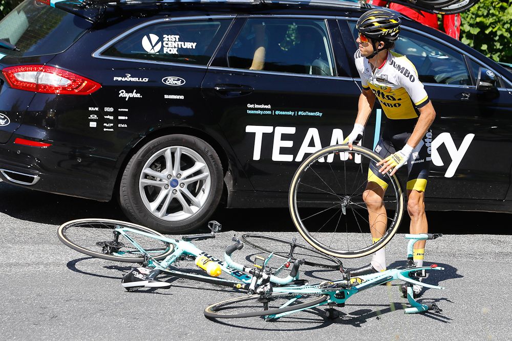George Bennett waits for a wheel change after giving his front wheel to Wilco Kelderman during stage 8 at the Tour de France.