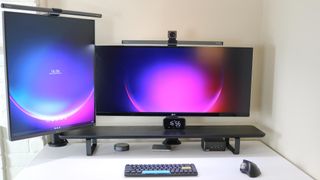 A multi-monitor desk setup built around the Asus NUC 14 Pro