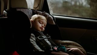 When do babies sleep through night illustrated by baby asleep in car