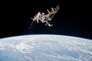 This photo of shuttle Endeavour at the International Space Station shows a rare look at the orbiter's underbelly while it is attached to the orbiting lab. This photo is one of the first-ever views of a NASA shuttle docked at the space station and was take