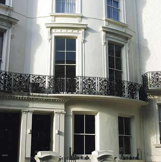 house with white walls and glass windows