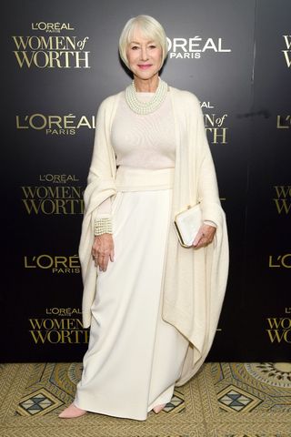 Helen Mirren wearing an all white outfit - skirt and cardigan