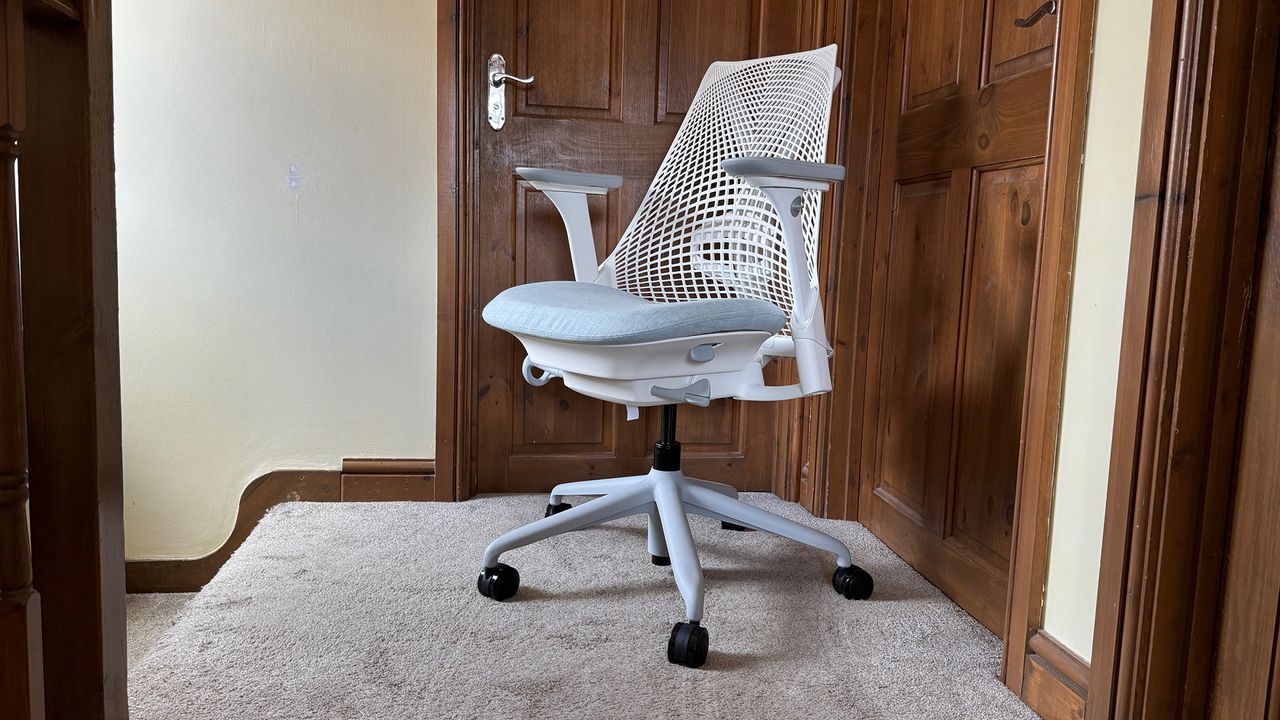 Three different shots of the Sayl chair in a hallway.