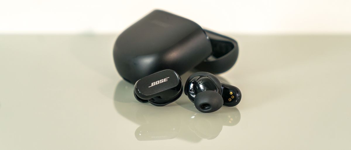 Bose QuietComfort Earbuds II earbuds loose in front of case.