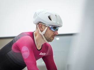 Tom riding in the wind tunnel wearing an aero helmet