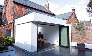 White rendered extension to brick semi-detached home