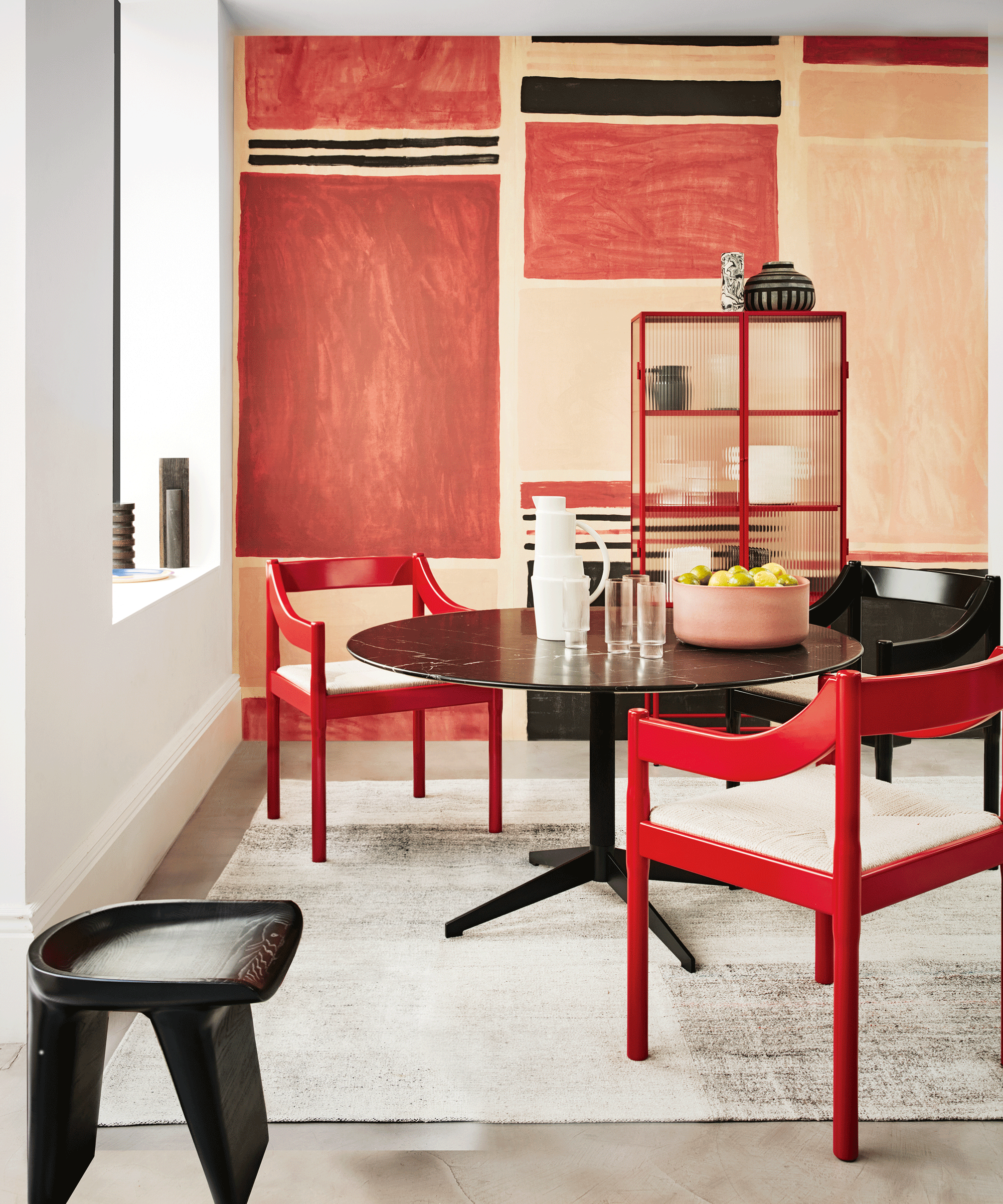 Dining area with red chairs and red wall