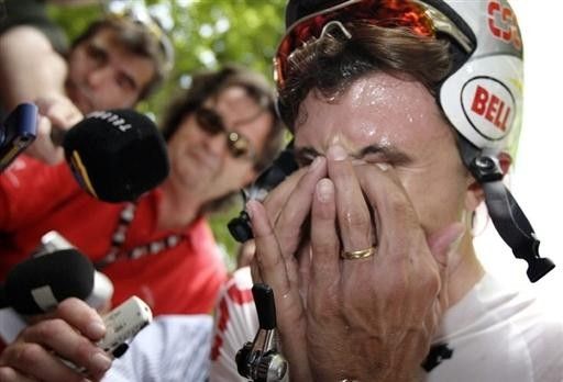 The winner receives the customary post-race treatment from journalists and photographers.