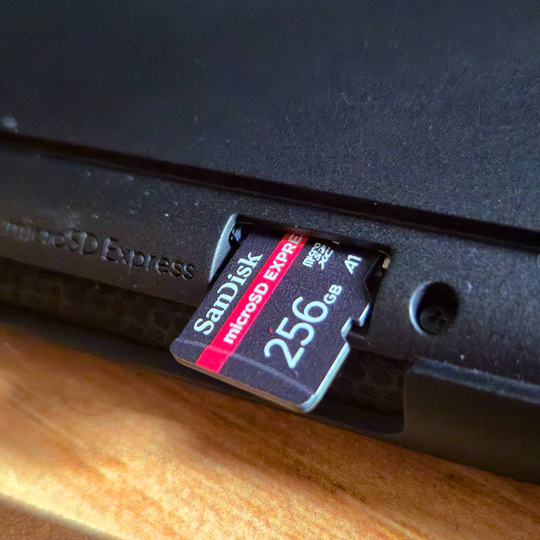 SanDisk 256GB microSD Express card sitting on Switch 2 slot.
