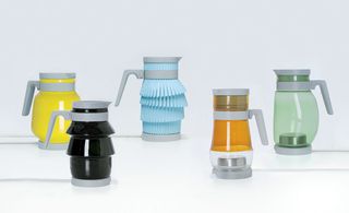 Colourful variations of electric kettles photographed on white surface against white wall