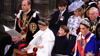 Prince Louis sits with his family and yawns during King Charles' Coronation
