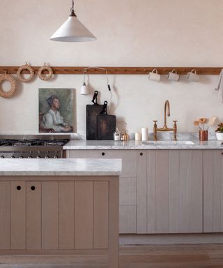 A gray and white kitchen with deVOL cabinetry, designed by Ellei Home