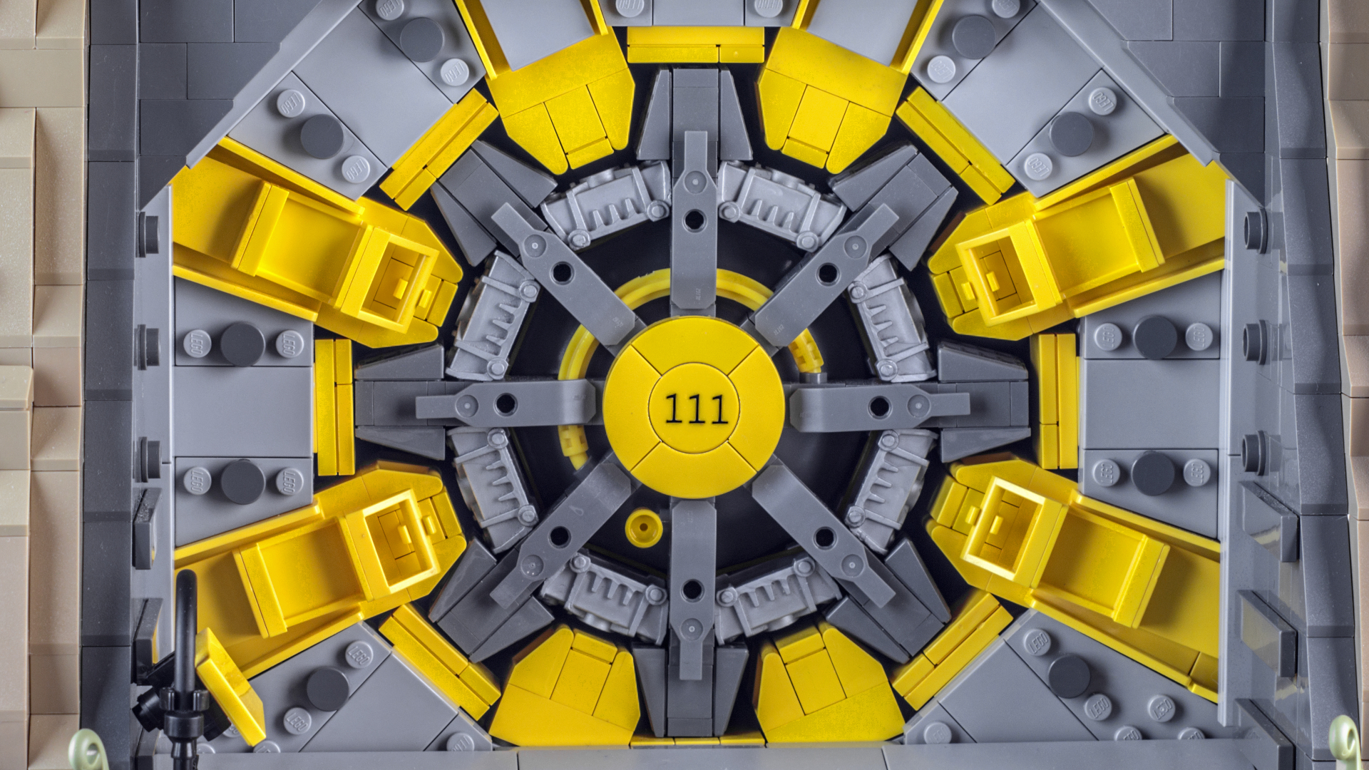 A Lego Vault 111 door made from yellow and gray pieces, seen head-on
