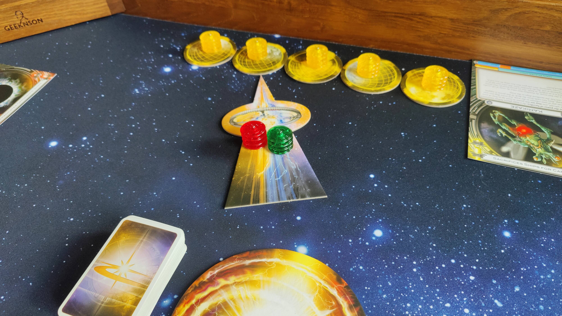 Red and green players attacking a yellow world in Cosmic Encounter.