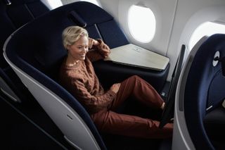 Woman in Finnair Business Class seat designed by PriestmanGoode